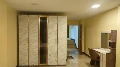 a bathroom with a closet with a sink and a staircase at indra apartments in Bangkok