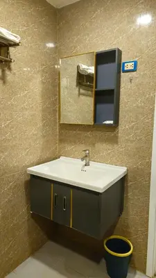 a bathroom with a sink and a mirror at indra apartments in Bangkok