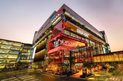 a tall red building with a sign on it at Contemporary Eastern 1BR 5 min BTS| All Essential in Khlong Toei