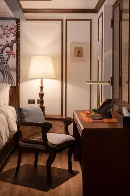 a bedroom with a desk with a chair and a lamp at Contemporary Eastern 1BR 5 min BTS| All Essential in Khlong Toei