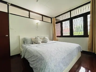 a bedroom with a white bed and two windows at 4BR House max 10pax, Near MRT and Local Place