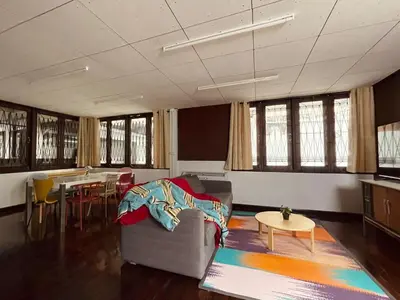 a room with a couch and a table and chairs at 4BR House max 10pax, Near MRT and Local Place