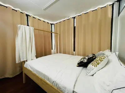 a bed with two pillows on it in a room at 4BR House max 10pax, Near MRT and Local Place