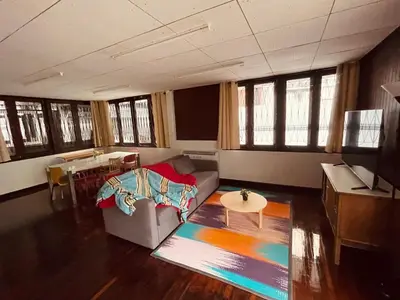 a living room with a couch and a table at 4BR House max 10pax, Near MRT and Local Place