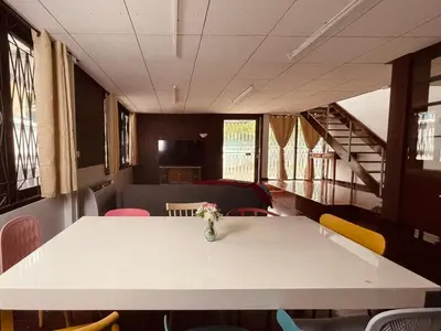 a table with a vase of flowers on top of it at 4BR House max 10pax, Near MRT and Local Place