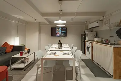 a kitchen and living room with a white table and chairs at 2BR APT on 2nd floor for 6 ppl in Bangkok