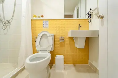 a bathroom with a toilet and a sink at A 3BR apartment for 8 pax on 3Floor in Bangkok