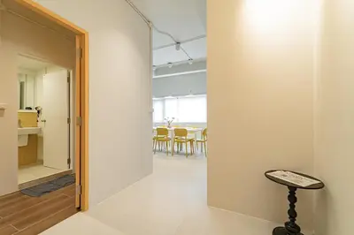 a room with a hallway with a table and a stool at A 3BR apartment for 8 pax on 3Floor in Bangkok