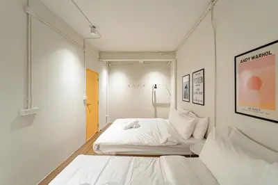 a white bedroom with a bed in a room at A 3BR apartment for 8 pax on 3Floor in Bangkok