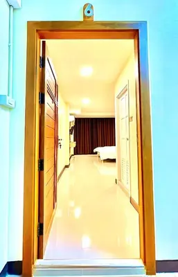 a hallway with a door open to a room at The Little Apartment in Bangkok