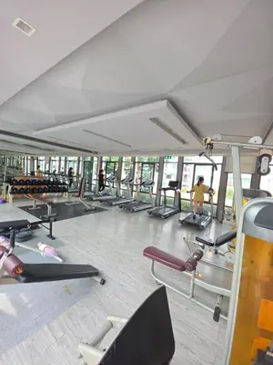 a gym with a bunch of treadmills and machines at FavStay Ramkhamhaeng, Stylish 1BR Bangkok in Bangkok