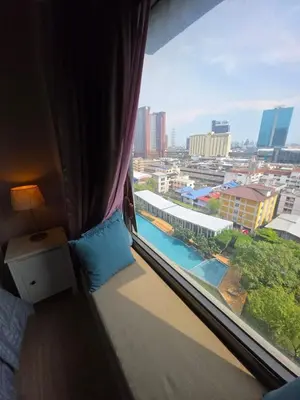 a room with a window with a view of a city at FavStay Ramkhamhaeng, Stylish 1BR Bangkok in Bangkok
