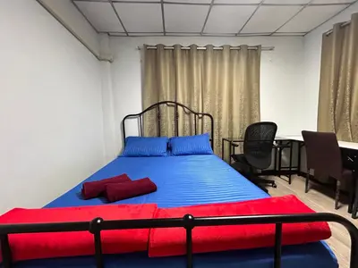 a bedroom with a bed with blue and red sheets at Wewash Room Laksi - Donmuang Airport ห้องวีวอช หลักสี่ -สนามบินดอนเมือง in Thung Si Kan