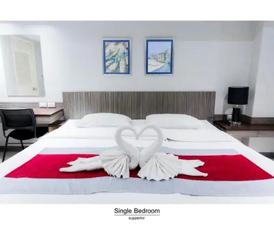two white swans forming a heart on a bed at Pho Place in Bangkok