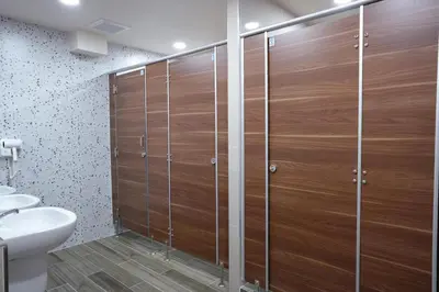 a bathroom with a shower with wooden doors at Cozy KingsizeBed เจริญนคร