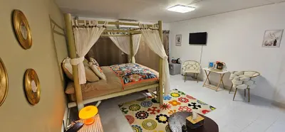 a bedroom with a bunk bed and a living room at Hotel pretty rooms in Pak Kret