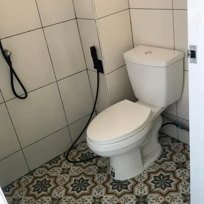 a bathroom with a white toilet in a room at TongmuanHomestay&Bar in Bangkok Noi