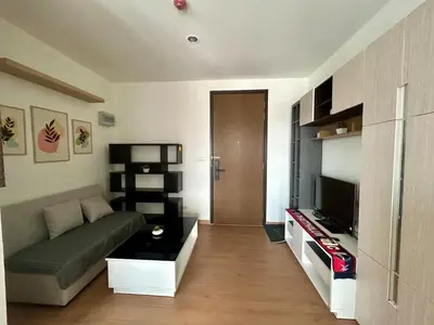 a living room with a couch and a television at Sky View at The Parkland Ngamwongwan-Khae Rai by Orn in Nonthaburi