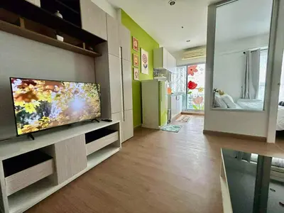 a living room with a flat screen tv on a wall at Sky View at The Parkland Ngamwongwan-Khae Rai by Orn in Nonthaburi
