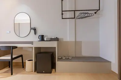 a desk with a mirror and a basketball hoop at The Bentley Hotel in Bangkok