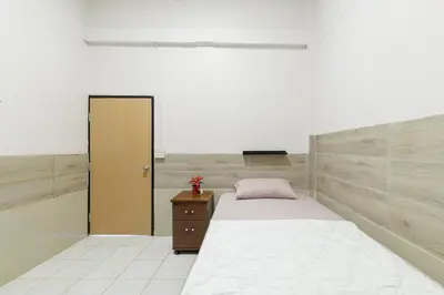 a bedroom with a bed and a cabinet and a door at Room 1 Homestay Near BTS Bangwa in Bangkok