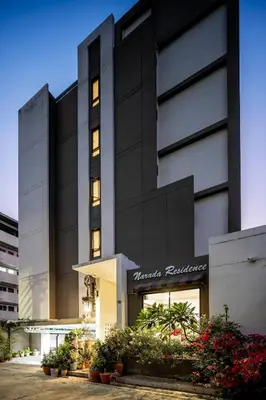 a large building with plants in front of it at Narada Residence in Pak Kret