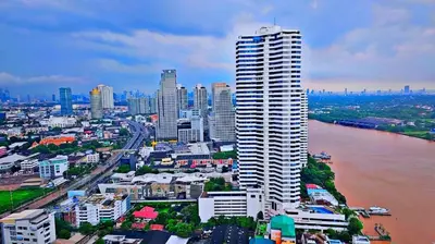 a view of a city with a tall building at River View Bangkok Apartment in Bangkok