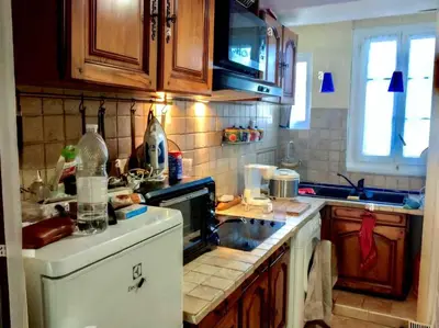 a kitchen with a sink and a stove top oven at River View Bangkok Apartment in Bangkok