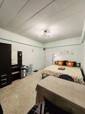 a bedroom with a bed and a dresser and a table at 706-STP Homely room Free Wi-Fi and Near BTS in Bangkok
