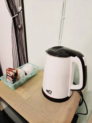 a black and white coffee pot sitting on a table at 706-STP Homely room Free Wi-Fi and Near BTS in Bangkok