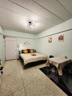 a bedroom with a bed and a table in it at 706-STP Homely room Free Wi-Fi and Near BTS in Bangkok