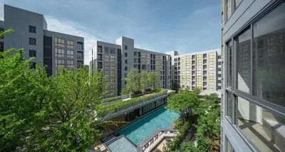 an apartment complex with a swimming pool in a city at 1 bed apartment at Phra Khnong in Bangkok