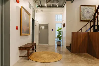 a hallway with a bench and a stair case at Samranscape in Bangkok