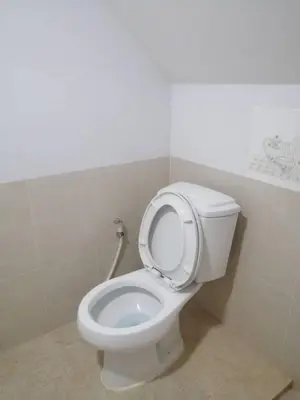 a bathroom with a toilet with the seat up at KS RESIDENCE Victory Monument in Bangkok