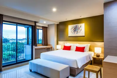 a bedroom with a large bed and a large window at Livotel Hotel Kaset Nawamin Bangkok in Bangkok