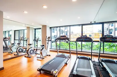 a gym with treadmills and elliptical machines at Livotel Hotel Kaset Nawamin Bangkok in Bangkok