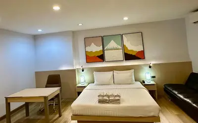 a hotel room with a bed and a couch at Sakura Sky Residence in Bangkok