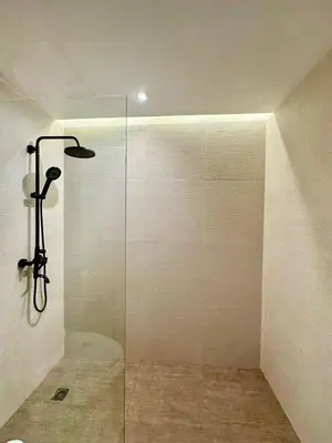 a shower with a glass door in a bathroom at Sakura Sky Residence in Bangkok
