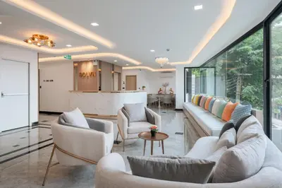a living room with two couches and a table at Solyn Hotel in Bangkok