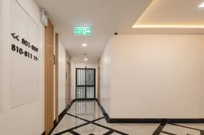 an empty hallway with a sign on the wall at Solyn Hotel in Bangkok
