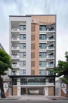 an external view of a tall apartment building at Solyn Hotel in Bangkok