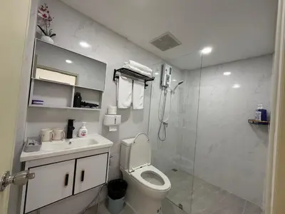 a bathroom with a toilet and a sink and a shower at Sukhumvit 48 separated room quiet and comfortable with fast internet and smart TV in Bangkok