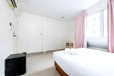 a white bedroom with a bed and a tv at XX Oh My Nap Sukhumvit 3 - Nana Bangkok in Makkasan