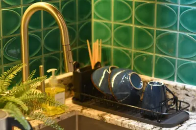 a kitchen sink with a tea pot and a mug at Pillow & Paper in Bangkok