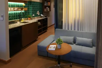 a living room with a blue couch and a table at Pillow & Paper in Bangkok