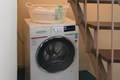 a washing machine with a basket on top of it at Pillow & Paper in Bangkok