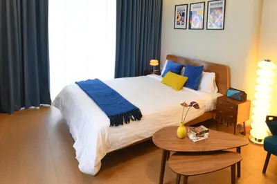a bedroom with a large bed and a table at Pillow & Paper in Bangkok