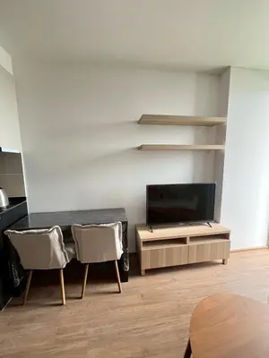 a living room with a tv and a table and chairs at Stay in near International airport in Bangkok