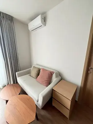 a living room with a couch and two tables at Stay in near International airport in Bangkok