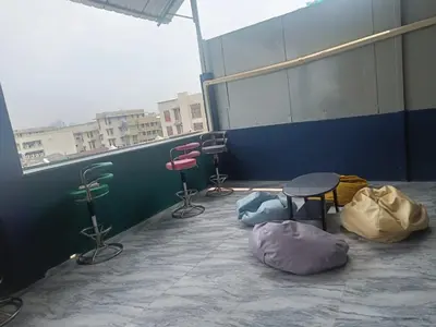 a room with chairs and a table and a window at RoXx Social Hostel in Bangkok